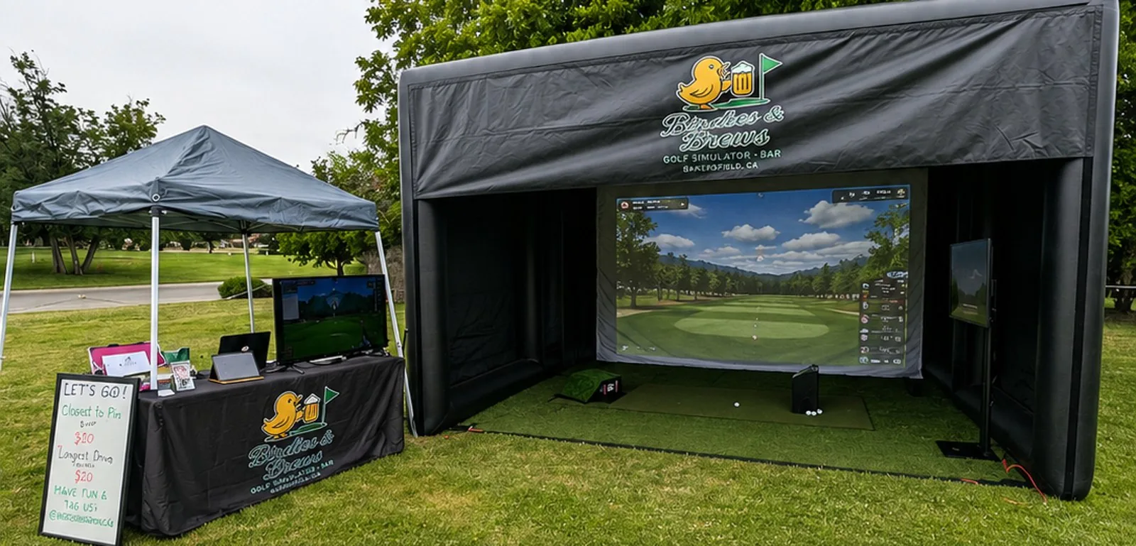 The full-size Birdies & Brews inflatable golf simulator bay set up outdoors on grass.